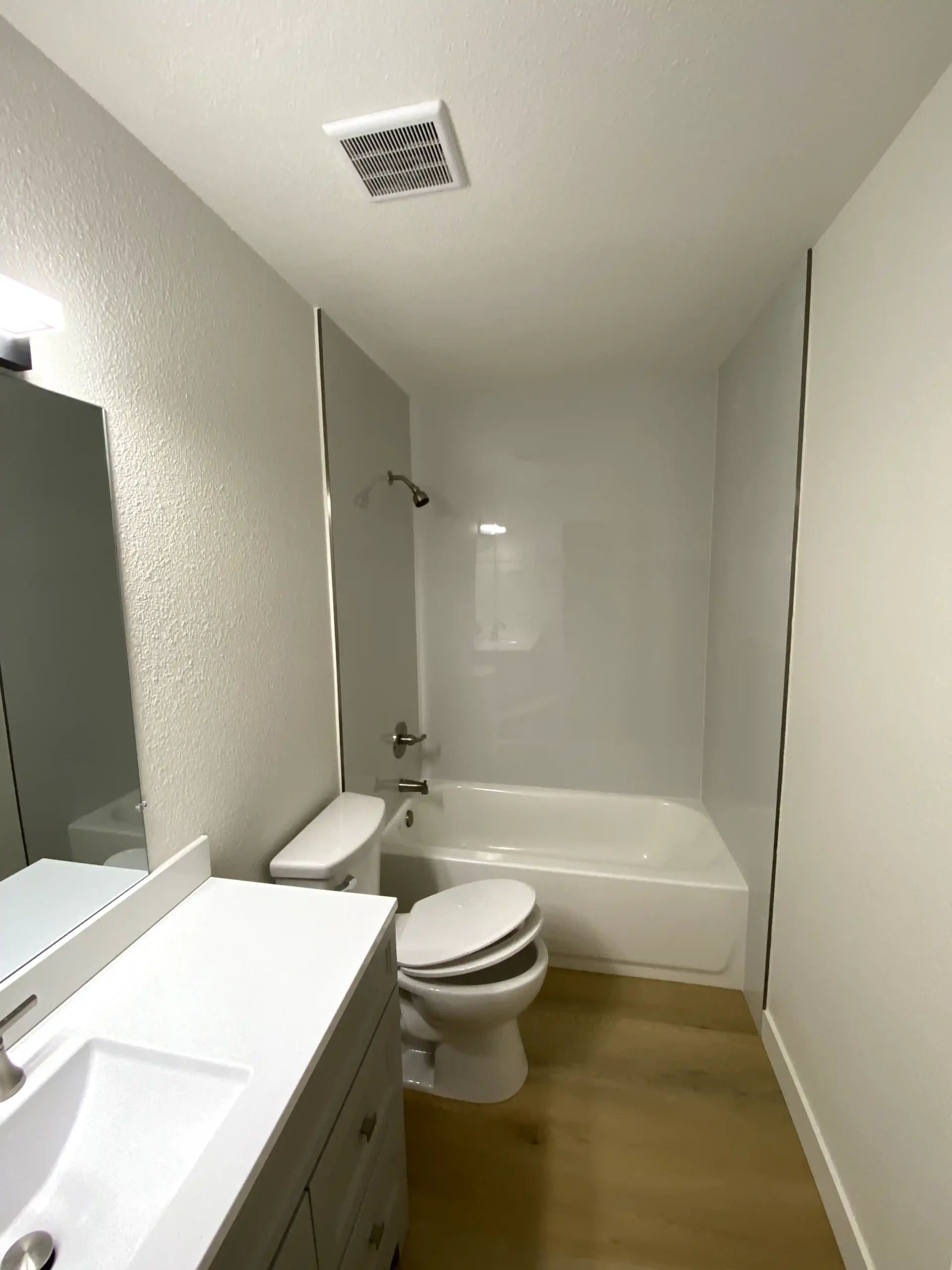 Tub surround remodel in Orangevale with clean white wall panels, bathtub, shower fixtures, and low-maintenance bathroom finish.