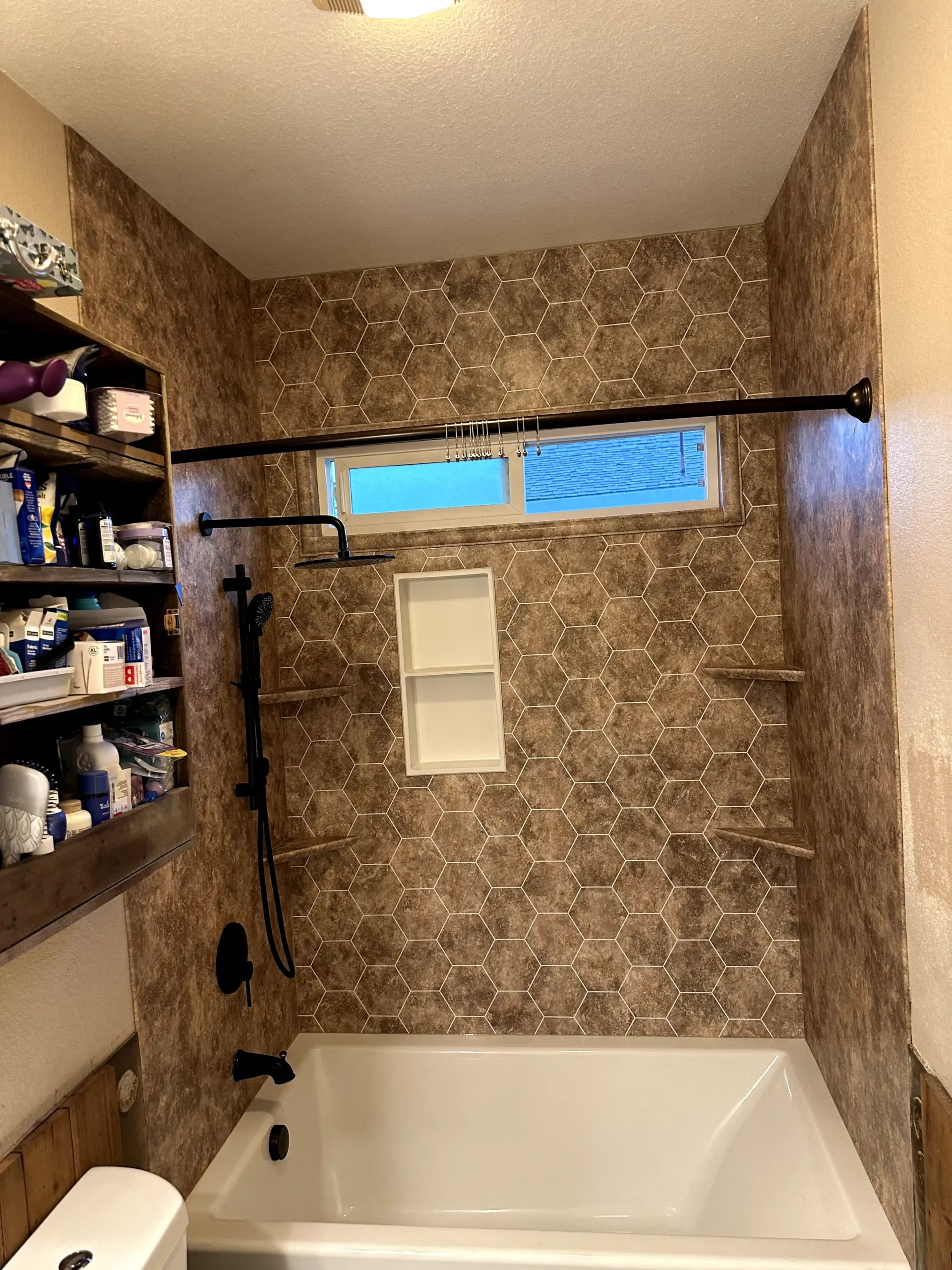Bright guest bathroom remodel in Fair Oaks with white vanity, brass hardware, marble-look flooring, arched tub area, and blue accent tile.